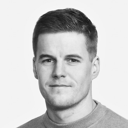 A black-and-white portrait of Salvos employee Petteri Laurila wearing a light-colored sweater